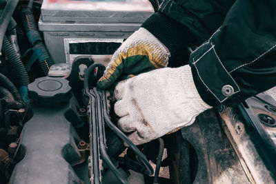 Midsection of man repairing car