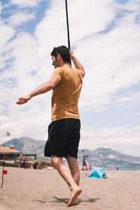 Full length of man on beach against sky