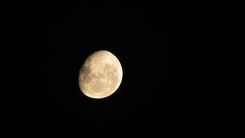 Low angle view of full moon against clear sky at night