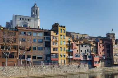 Buildings in city against clear sky