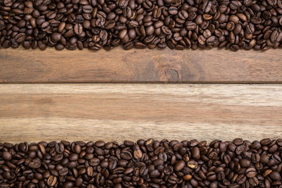 Directly above shot of roasted coffee beans on wooden table