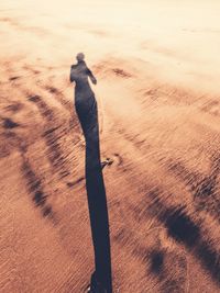 Shadow of person on sand