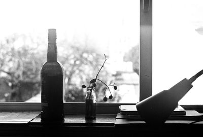 Close-up of books on table against window