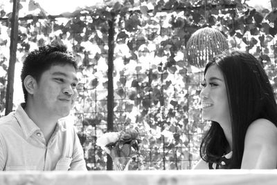 Portrait of smiling young couple looking at outdoors