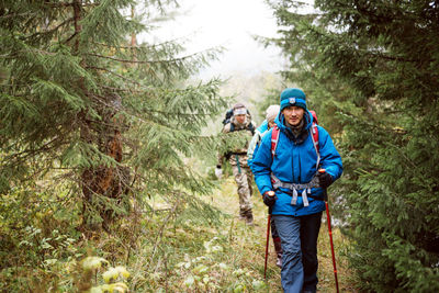 Portrait of smiling man standing in forest