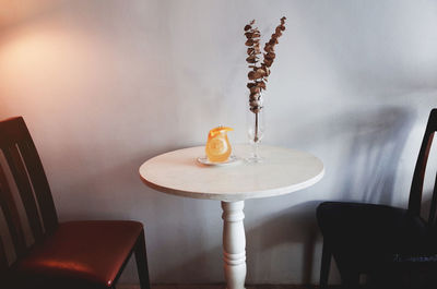 Empty chairs and table against wall at home