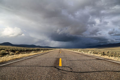 Scenic view of road against cloudy sky