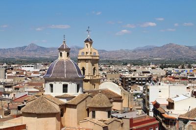 High angle view of buildings in city against sky