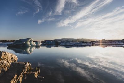 Scenic view of lake against sky during winter