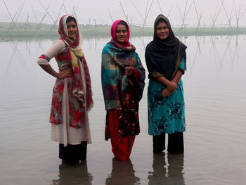 Village girls are standing in the river water