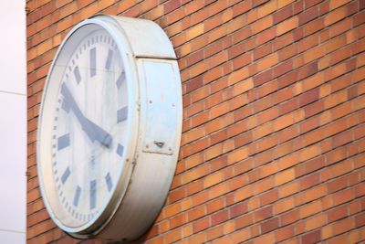 Low angle view of clock on wall