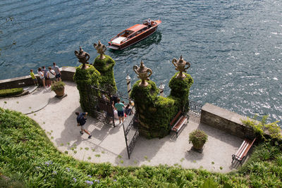 High angle view of fancy boat on a lake with villa entrance and grass