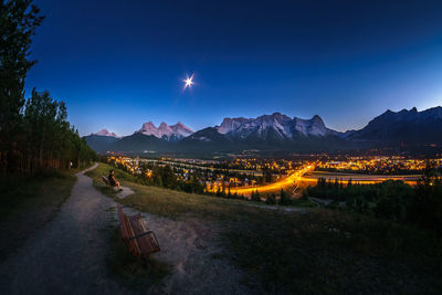 Panoramic view of illuminated mountains against clear sky at night