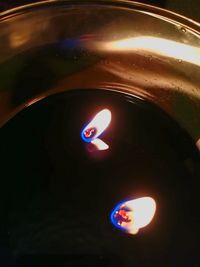 High angle view of lit candle in the dark