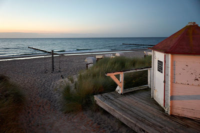 Scenic view of beach against sky during sunset