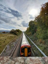 Train on railroad track against sky