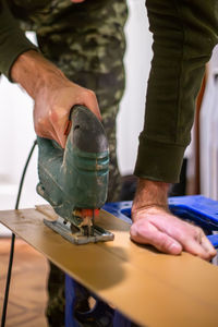 Midsection of man working in workshop