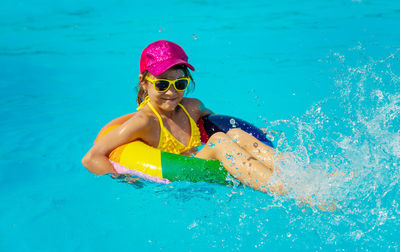 Portrait of woman swimming in pool