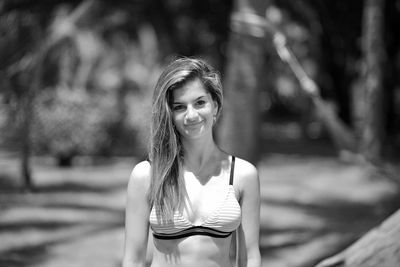 Portrait of smiling young woman standing outdoors