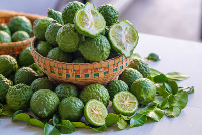 Close-up of bergamot orange in basket on table