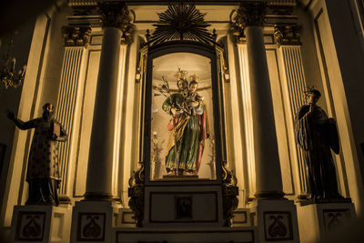 Low angle view of statues in church at night