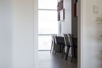 Empty chair on table by window in building