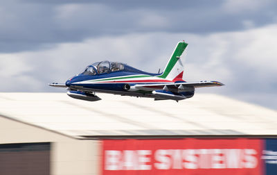Low angle view of airplane flying against sky