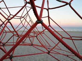 Close-up of metallic structure on sea against clear sky