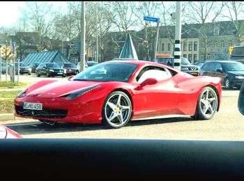 Red car on road in city