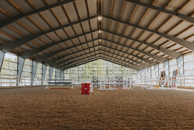 View of empty indoor riding paddock
