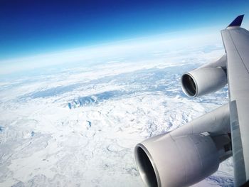 Cropped image of airplane flying over landscape