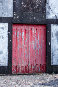 Red closed door of old building