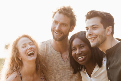 Portrait of smiling friends against white background