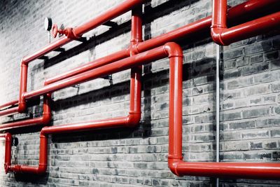 Close-up of red pipe against wall