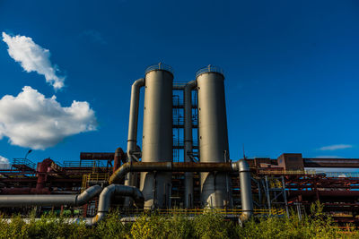 Low angle view of factory against sky