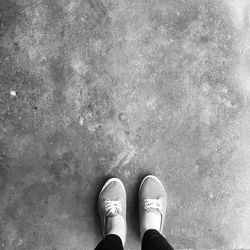 Low section of person standing in puddle