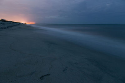 Scenic view of beach against sky during sunset