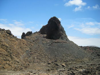 Low angle view of rock formations against sky