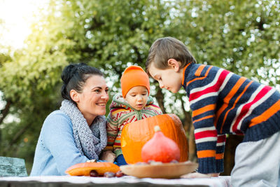 Mother with daughter and son sitting in garden