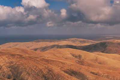 Volcanic landscape with blue sky and clouds