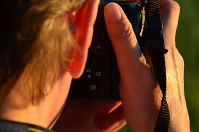 Rear view of woman photographing