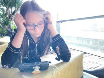 Portrait of girl looking away while sitting on table