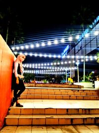 Man walking on footpath at night