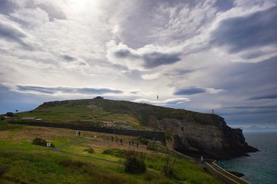Scenic view of landscape against cloudy sky