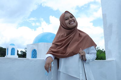 The photo of a woman smiling in front of her looks so happy