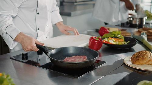 Midsection of man preparing food on table