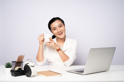 Portrait of smiling young woman using mobile phone