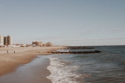 View of beach with city in background
