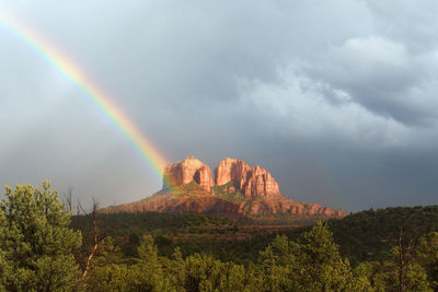 Rainbow over mountain against sky