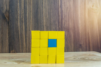 Close-up of yellow toy on wooden table